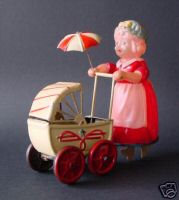 Celluloid wind up girl with pram 